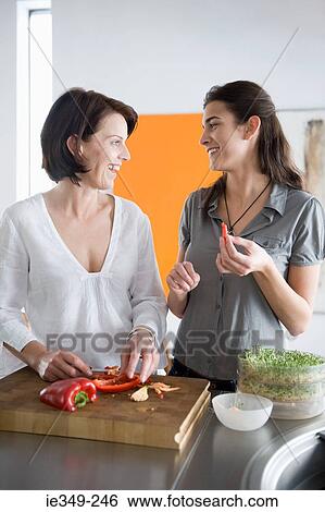 Mother and daughter preparing food View Large Photo Image Stock Photograph - Mother and daughter preparing food. Fotosearch