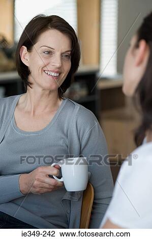 Mother listening to daughter View Large Photo Image Stock Image - Mother listening to daughter. Fotosearch