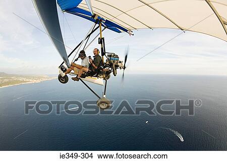 Pilot and photographer on ultralight aircraft View Large Photo Image Picture - Pilot and photographer on ultralight aircraft. Fotosearch