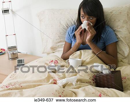 Woman in bed with cold View Large Photo Image Stock Photo - Woman in bed with cold. Fotosearch