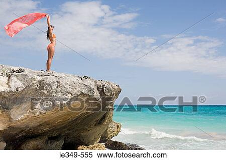 Woman standing on rocks View Large Photo Image Stock Photography - Woman standing on rocks. Fotosearch