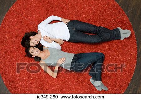 Women lying on rug View Large Photo Image Stock Image - Women lying on rug. Fotosearch