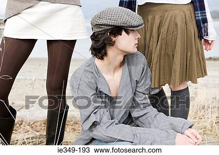 Stock Image - Young man and two young women. Fotosearch