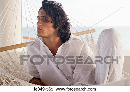 Young man in hammock View Large Photo Image Stock Photography - Young man in hammock. Fotosearch