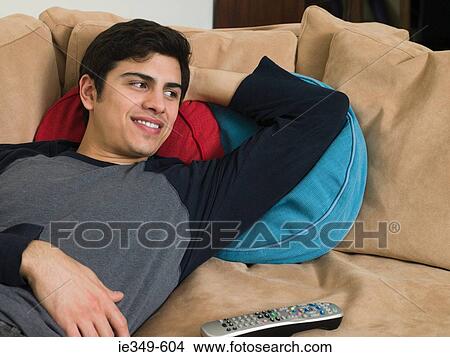 Picture - Young man watching television. Fotosearch