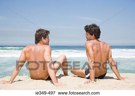 Stock Photo - Young men by the sea. Fotosearch