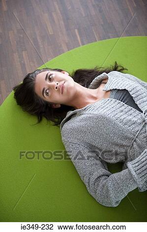 Young woman lying on floor View Large Photo Image Stock Image - Young woman lying on floor. Fotosearch