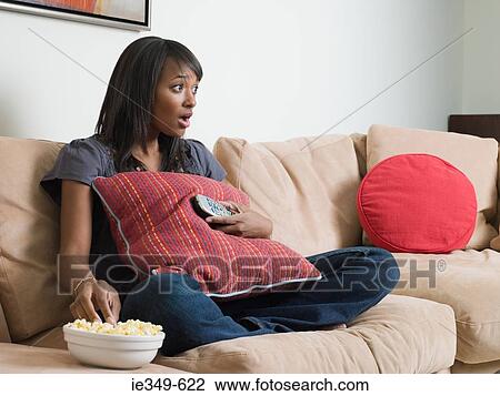 Young woman watching television View Large Photo Image Stock Image - Young woman watching television. Fotosearch