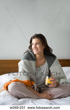 Young woman with glass of juice View Large Photo Image Stock Image - Young woman with glass of juice. Fotosearch