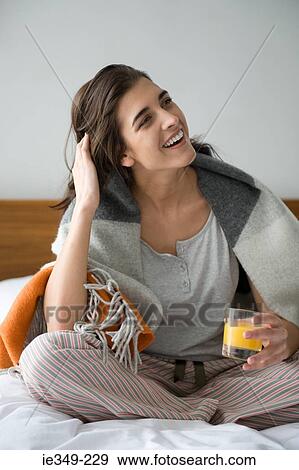Young woman with glass of juice View Large Photo Image Stock Photo - Young woman with glass of juice. Fotosearch