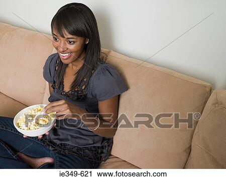 Young woman with popcorn View Large Photo Image Stock Image - Young woman with popcorn. Fotosearch
