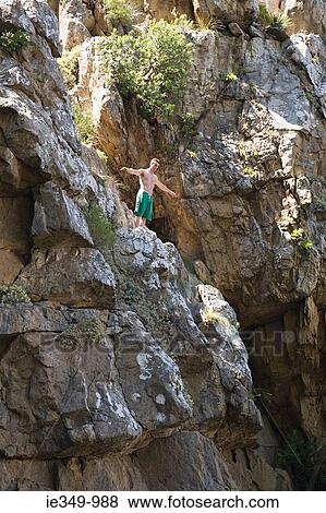 Man about to jump off rock View Large Photo Image Stock Photo - Man about to jump off rock. Fotosearch