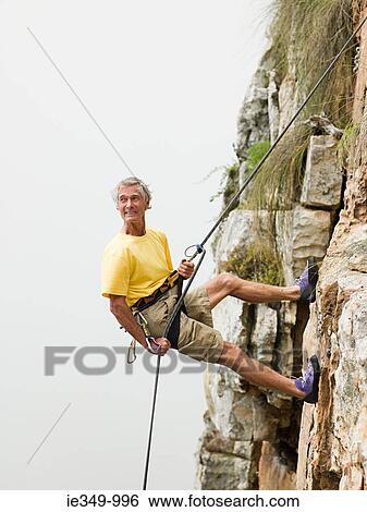 Stock Photograph - Man abseiling. Fotosearch