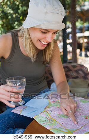 Young woman looking at map View Large Photo Image Stock Photo - Young woman looking at map. Fotosearch