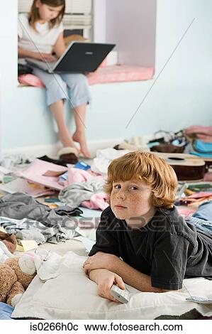 A boy and girl in a messy bedroom View Large Photo Image Stock Image - A boy and girl in a messy bedroom. Fotosearch