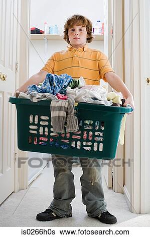 Stock Photograph - A boy carrying a laundry basket. Fotosearch