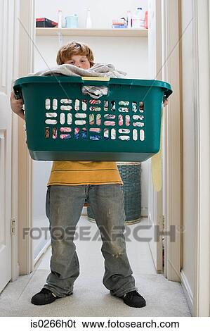 A boy carrying a laundry basket View Large Photo Image Stock Photograph - A boy carrying a laundry basket. Fotosearch