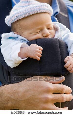 A father carrying his baby in a baby carrier View Large Photo Image Stock Photography - A father carrying his baby in a baby carrier. Fotosearch