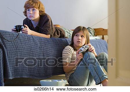 Picture - Brother and sister playing a video game. Fotosearch