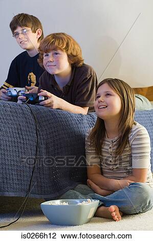 Friends playing a video game View Large Photo Image Stock Image - Friends playing a video game. Fotosearch