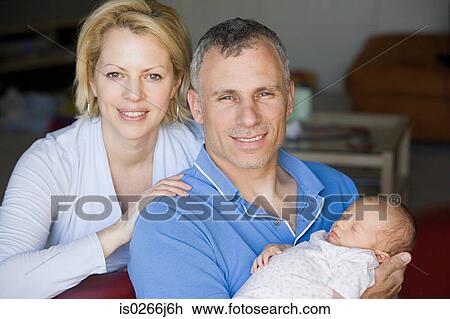 Portrait of parents with their baby daughter View Large Photo Image Stock Image - Portrait of parents with their baby daughter. Fotosearch