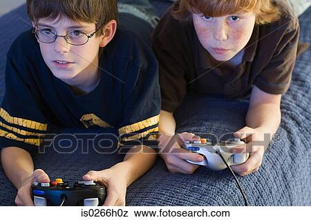 Stock Photo - Two boys playing a video game. Fotosearch