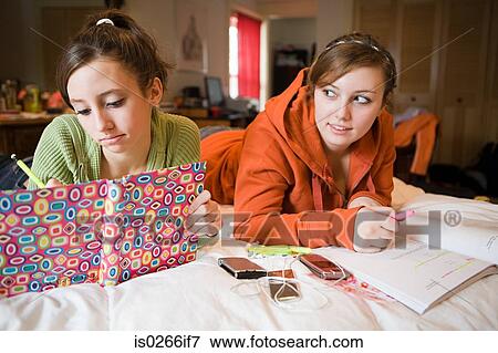 Two teenage girls doing their homework View Large Photo Image Stock Photo - Two teenage girls doing their homework. Fotosearch