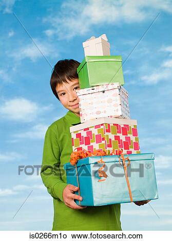 A boy carrying presents View Large Photo Image Picture - A boy carrying presents. Fotosearch