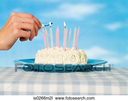 A person lighting matches on a cake View Large Photo Image Stock Image - A person lighting matches on a cake. Fotosearch