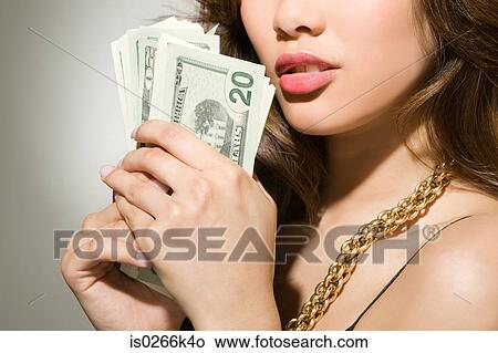 A woman holding banknotes View Large Photo Image Picture - A woman holding banknotes. Fotosearch