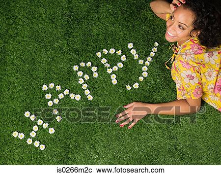 A woman lying on grass View Large Photo Image Stock Image - A woman lying on grass. Fotosearch