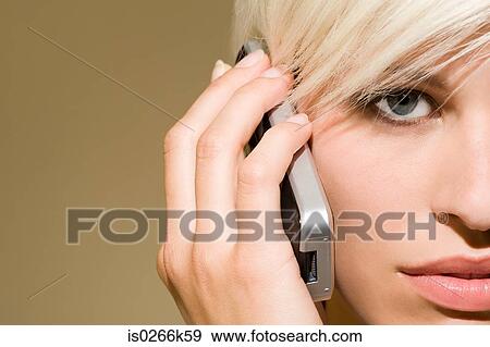 Stock Photo - A woman using a cell phone. Fotosearch