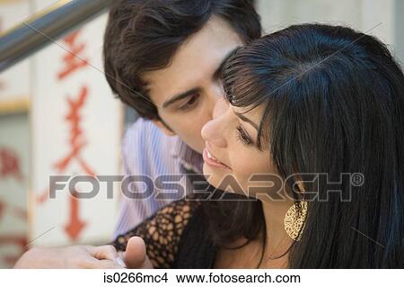 A young man kissing a woman on the cheek View Large Photo Image Picture - A young man kissing a woman on the cheek. Fotosearch