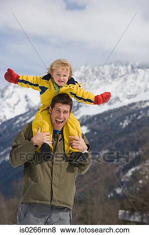 Boy on fathers shoulders View Large Photo Image Stock Photo - Boy on fathers shoulders. Fotosearch
