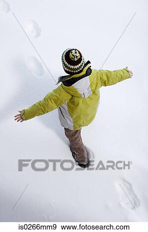 Boy walking in the snow View Large Photo Image Stock Photo - Boy walking in the snow. Fotosearch