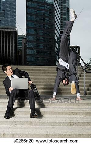 Businessman doing handstand View Large Photo Image Stock Image - Businessman doing handstand. Fotosearch