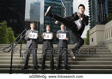 Stock Image - Businessman doing martial arts. Fotosearch