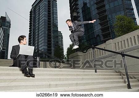 Businessman jumping at colleague View Large Photo Image Stock Photo - Businessman jumping at colleague. Fotosearch