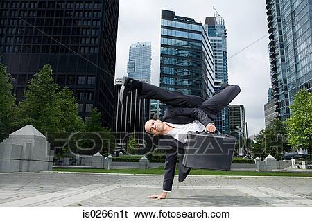 Stock Photograph - Businessman practising capoeira. Fotosearch