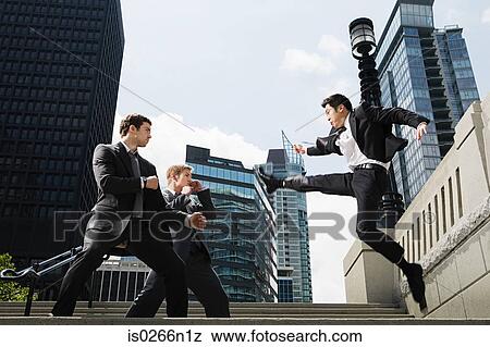 Stock Photo - Businessmen fighting. Fotosearch