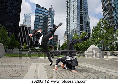 Businesspeople practising capoeira View Large Photo Image Stock Image - Businesspeople practising capoeira. Fotosearch