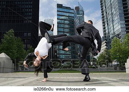Businesspeople practising capoeira View Large Photo Image Stock Photograph - Businesspeople practising capoeira. Fotosearch