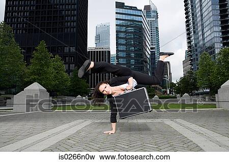Businesswoman practising capoeira View Large Photo Image Stock Photo - Businesswoman practising capoeira. Fotosearch