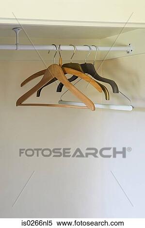 Coat hangers in wardrobe View Large Photo Image Stock Photography - Coat hangers in wardrobe. Fotosearch