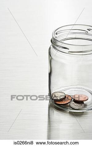 Stock Photo - Coins in a jar. Fotosearch