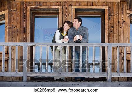 Couple at chalet View Large Photo Image Stock Photo - Couple at chalet. Fotosearch