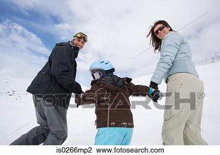 Stock Image - Family at ski resort. Fotosearch