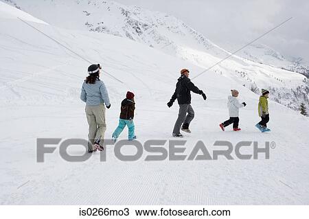 Family walking in the snow View Large Photo Image Stock Image - Family walking in the snow. Fotosearch