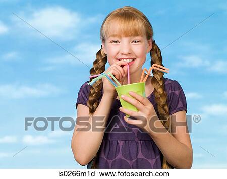 Girl drinking through a straw View Large Photo Image Stock Image - Girl drinking through a straw. Fotosearch