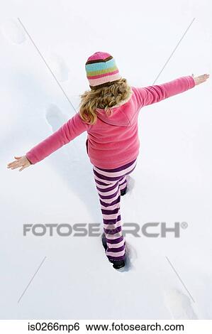 Girl walking in the snow View Large Photo Image Stock Photograph - Girl walking in the snow. Fotosearch